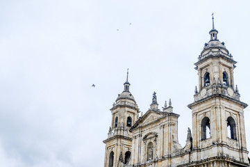 Fototapeta na wymiar Colombia. Bogota. Plaza de bolivar Exterior facade of the church in a collannic style against the sky.