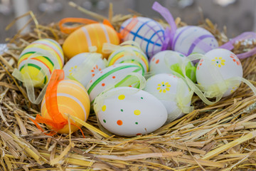 straw nest with easter eggs. Festive decoration for holidays