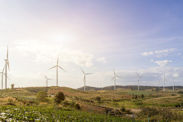 Wind turbines farm on mountanis landscape against blue sky with clouds background,Windmills for...