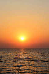 Beautiful burning yellow sunset at Jomtien beach Pattaya Thailand with silhouettes in the foreground 