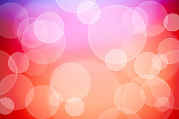 Defocused lights over colored red and pink background