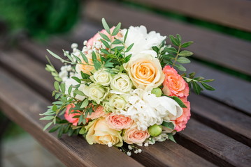 wedding bouquet in pink on a wooden bench