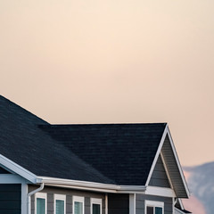 Fototapeta premium Square Cropped image of a house and mountain peak