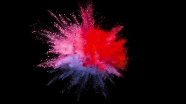 Colored powder explosion, abstract close up dust isolated on black background in slow motion
