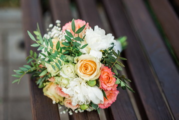 wedding bouquet in pink on a wooden bench
