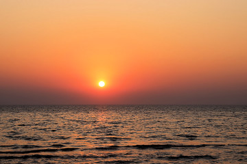 Beautiful burning yellow sunset at Jomtien beach Pattaya Thailand with silhouettes in the foreground 