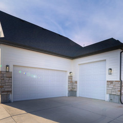 Square Two garages with paved forecourt and white doors © Jason
