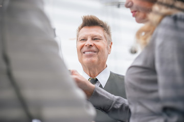 close up. senior businessman talking to his colleagues.