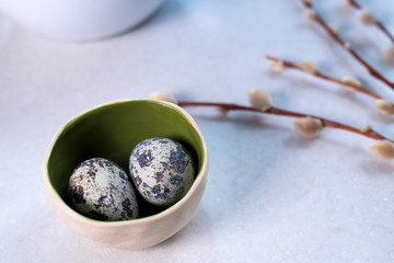 quail eggs in a white ceramic bowl. Easter decoration of kitchen