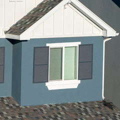 Square frame Grey and white house facade with shutters