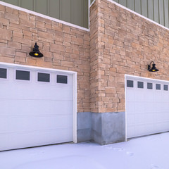 Square Snow covered forecourt with double garage doors © Jason