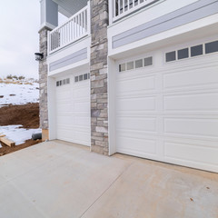 Square frame White garage doors overlooking winter snow day light