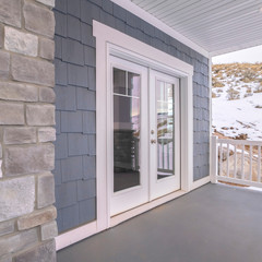 Square Glass front door to a house with covered porch