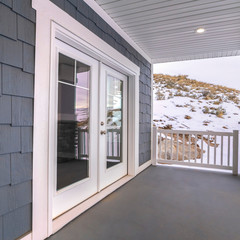 Square frame View from a covered front veranda of winter snow