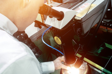 Laser welding of small parts using a microscope