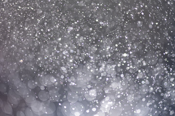 Abstract bokeh from light and water spray in backgrounds of various colors