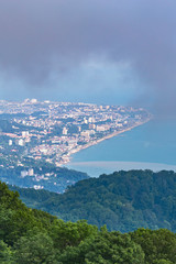 Fototapeta premium the view from the mountains to the resort town of Sochi in summer rainy day