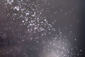 Abstract bokeh from light and water spray in backgrounds of various colors