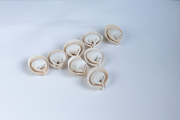 Several raw, frozen dumplings on a light background. View from above.