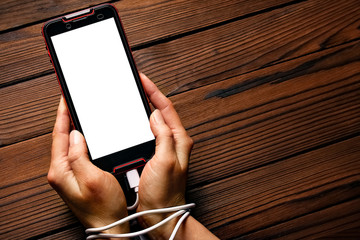 phone in hands addiction on a wooden background