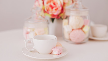 Fototapeta na wymiar White cup with marshmallows. Romantic breakfast. Concept of holiday, birthday, Easter, International Womens Day. Feminine flat lay