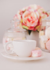 White cup with marshmallows. Romantic breakfast. Concept of holiday, birthday, Easter, International Womens Day. Feminine flat lay