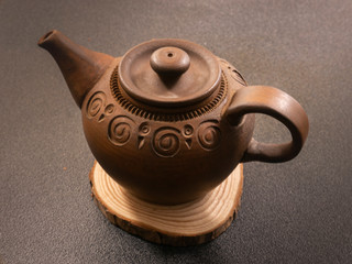 clay teapot on a wooden stand