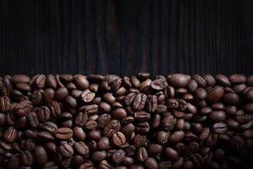 Coffee beans on wood background
