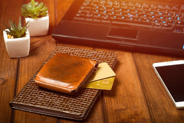 online shopping, online store shopping concept, laptop on a wooden table, wallet and bank cards, phone, office desktop