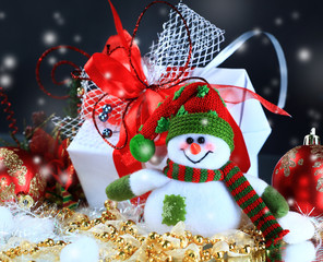 close up. merry snowman on the background of Christmas gifts