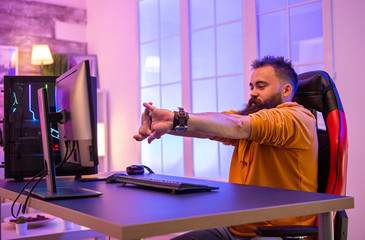 Bearded man sitting on gaming chair preparing to play video games © DC Studio