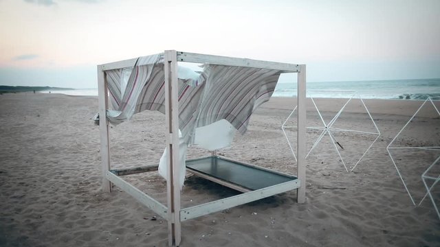 Deserted canopy bed at the beach.