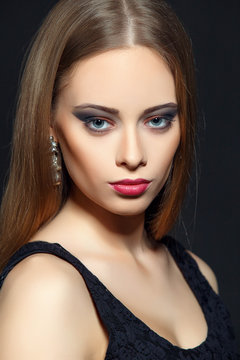 High Fashion model woman  posing in studio, portrait of beautiful sexy girl with trendy evening  make-up . Art design, colorful make up. Black background