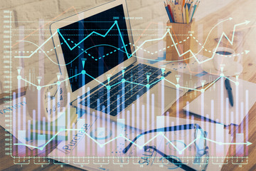 Double exposure of chart and financial info and work space with computer background. Concept of international online trading.