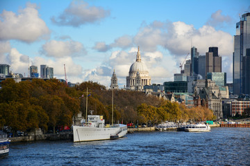 Panoramic view of London, UK, from Waterloo Bridge with the Thames, autumn trees on Victoria embankment, the dome of St Paul's Cathedral and the skyscrapers of City of London