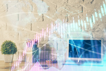Financial chart drawing and table with computer on background. Double exposure. Concept of international markets.