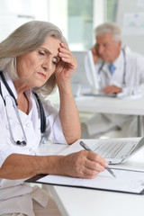 Close up portrait of professional doctors working in cabinet