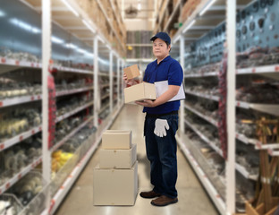 Male staff and parcel boxes checking stock and Blurred the background of the warehouse