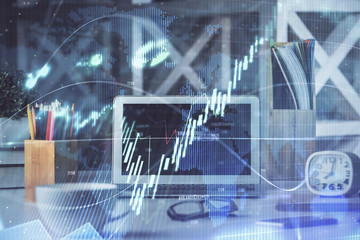 Financial chart drawing and table with computer on background. Double exposure. Concept of international markets.