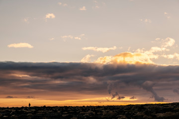 Sunset landscape of mountains and volcanic rock soil