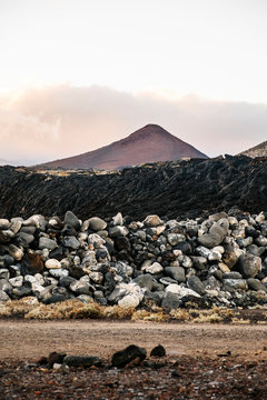 Sunset landscape of mountains and volcanic rock soil