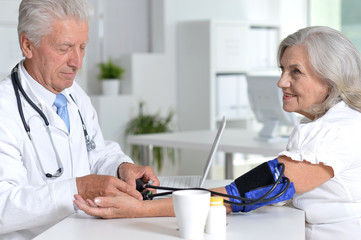 Portrait of senior doctor with a elderly patient