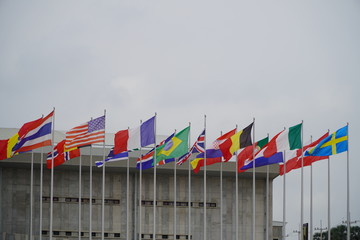 Flags of different countries flutters in the wind against