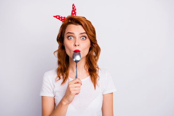 Portrait of astonished woman lick spoon impressed about yummy super snack taste look stupor wear t-shirt isolated over white color background