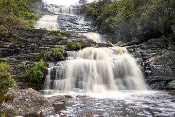 Close up of a beautiful cascading waterfall with water motion blur and pond, Caraca natural park, Minas Gerais, Brazil