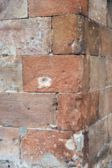 Detail of Textured Corner Stones of Old Worn Masonry Wall 