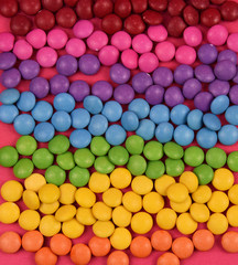Fototapeta na wymiar Stack of colorful candies stock images. Colorful candies texture background. Rainbow colorful candy coated chocolate pieces. Mix of candies top view