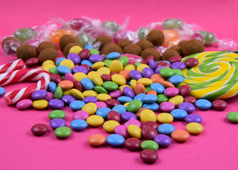 Fototapeta na wymiar Colorful candies on a pink background stock images. Sweets on pink background. Candy on a pink background. Candies and lollipops images
