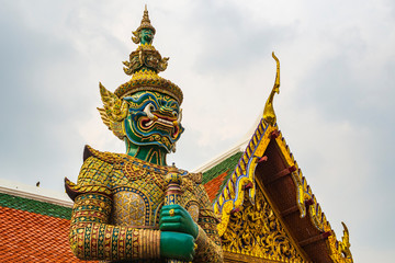 Travel concept, Giant statue at Temple Wat Pra Kaew, Grand Palace, Bangkok Thailand