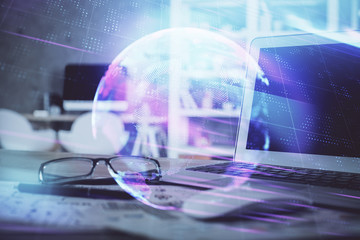 Computer on desktop in office with technology theme hologram. Multi exposure. Tech concept.